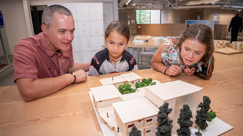 Guests viewing a student's final model from the Architecture Studio at the end-of-the-year student showcase