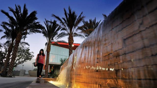 SMC Student walking by fountain