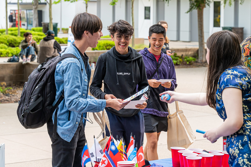 Students chatting by a table.